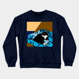 Cute Tuxedo cat laying in a paw print bed Crewneck Sweatshirt